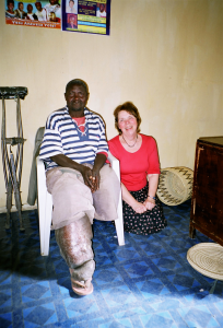 Philip seated at a medical clinic, his leg treated and bandaged